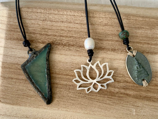 Leather necklaces with either a seaglass, lotus or Buddha pendant.