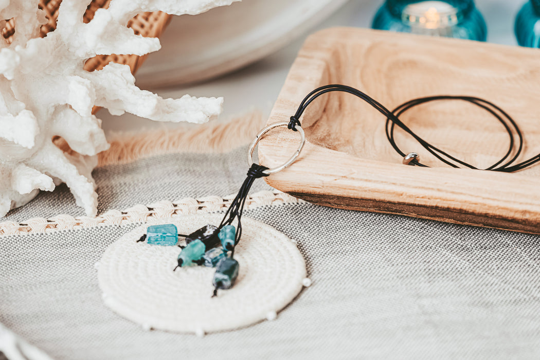 circle pendant with roman glass dangles on adjustable leather cord